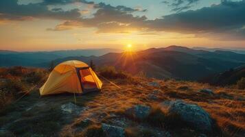 Sunset view with tent on mountain ridge photo