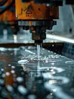 Machine using water pressure to cut through stainless steel materials photo