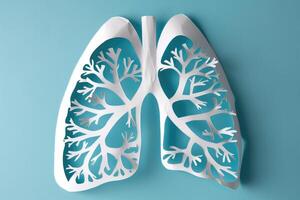 Paper model of human lungs on light blue background. Respiratory health, health diagnostic concept. World no tobacco day. photo