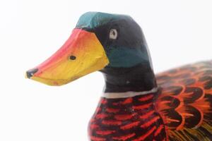 Close up photo of a typical Indonesian toy duck made of wood and painted colors