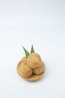 Portrait photo of a snack that has a golden round shape is often called Onde Onde