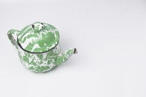 the classic green and white teapot is a typical Indonesian teapot used to serve sweet tea photo