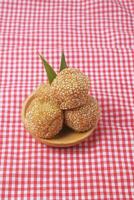 Indonesian traditional food called onde onde is a sesame coated sticky rice ball photo