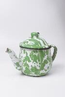 A teapot with green and white stripes which is a traditional Indonesian teapot photo