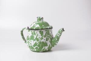 A teapot with green and white stripes which is a traditional Indonesian teapot photo