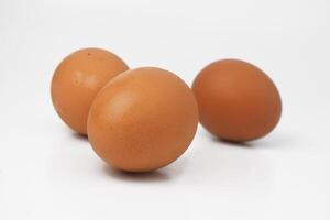 Some chicken eggs are on a white background photo