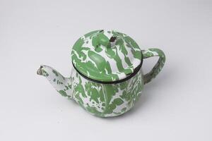 the classic green and white teapot is a typical Indonesian teapot used to serve sweet tea photo