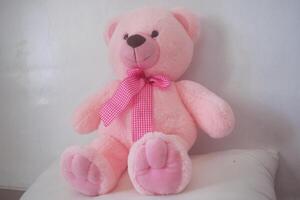 A pink teddy bear that has soft fur photo