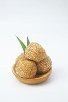 Portrait photo of a snack that has a golden round shape is often called Onde Onde