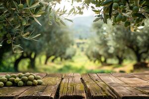 Empty old wooden table for product display with natural green olive field and green olives photo