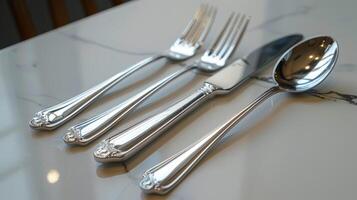 Elegant stainless steel cutlery set on marble photo