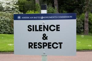 Courtesy sign at American cemetery at Normandy area. photo