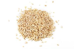 Portion of Raw organic oat flakes isolated on white background. Photography for packaging photo