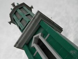 Photo of the mosque tower taken from the top floor of a multi-storey building. The mosque tower is used as a marker and also as a loudspeaker