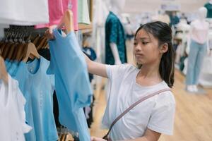 A girl is shopping for clothes in a store photo