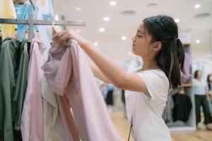 A girl is shopping for clothes in a store photo