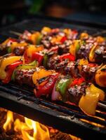 Skewers of meat on the grill with onions and peppers. photo