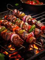 Skewers of meat on the grill with onions and peppers. photo