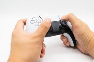 controller on male hand in isolated background. Controller console playing player holding hobby playful enjoyment. photo