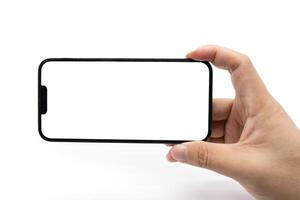 Hand holding blank screen smartphone for copy space isolated on white background. Male hands showing empty white screen of modern smart phone. Clipping path photo