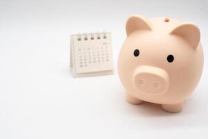 Piggy Bank and Desk calendar. For retirement, Pension Plan concept. Time for a new start. copy space. photo