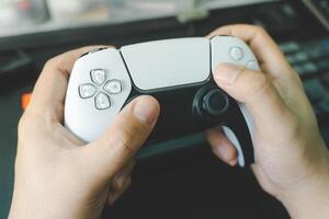 Console gamepad new generation on male hand background. Controller console playing player holding hobby playful enjoyment. photo