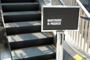 Maintenance in progress sign. Maintenance of escalators. photo