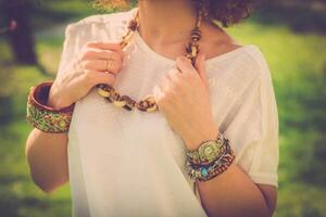 Fashion shot of a beautiful boho style girl on nature background. Boho, hippie. photo