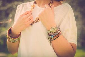 Fashion shot of a beautiful boho style girl on nature background. Boho, hippie. photo