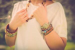 Fashion shot of a beautiful boho style girl on nature background. Boho, hippie. photo