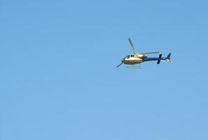 Helicopter flying over the river photo