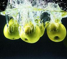 Green apples in water photo