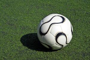 football or soccer ball on the grass photo