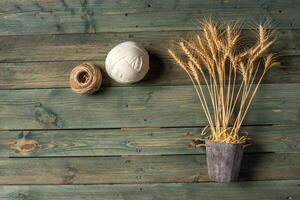 Wheat Ears on the Wooden Table. Sheaf of Wheat over Wood Background. Harvest concept. photo