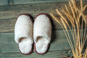 White slippers on the wooden background. Beauty and fashion. photo