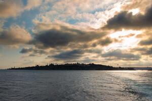 Silhouette of Istanbul at sunset with dramatic clouds view from a ferry photo