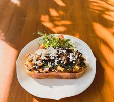 Healthy breakfast with srambled eggs, spinach and on toasted sourdough bread. photo