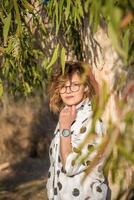 Fashion shot of a beautiful boho style girl on nature background. Boho, hippie. photo