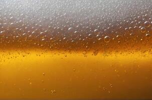close up of bubbles beer froth in glass, golden bubbles beer or oil photo