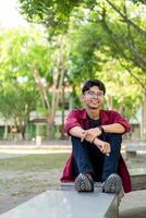 Portrait of Asian college student at the campus park. photo