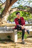 Portrait of Asian college student at the campus park. photo