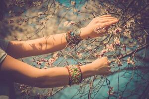 Fashion shot of a beautiful boho style girl on nature background. Boho, hippie. photo