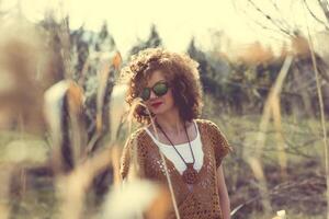 Fashion shot of a beautiful boho style girl on nature background. Boho, hippie photo