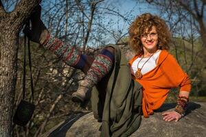 Fashion shot of a beautiful boho style girl on nature background. Boho, hippie photo