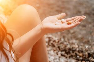 Woman eating milky almond nuts. A young caucasian woman chopping fresh green almond after morning fitness yoga near sea. Only hands are visibly. Healthy vegan food. Slow motion. Close up photo