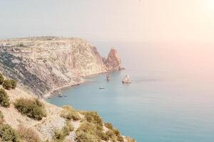 Aerial view from above on calm azure sea and volcanic rocky shores. Small waves on water surface in motion blur. Nature summer ocean sea beach background. Nobody. Holiday, vacation and travel concept photo