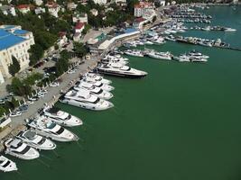 Aerial panoramic view of Balaklava landscape with boats and sea in marina bay. Crimea Sevastopol tourist attraction. Drone top view shot of port for luxury yachts, boats and sailboats. photo