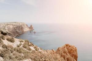 Aerial view from above on calm azure sea and volcanic rocky shores. Small waves on water surface in motion blur. Nature summer ocean sea beach background. Nobody. Holiday, vacation and travel concept photo