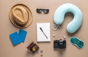 Packed suitcase of vacation items on wooden table, top view photo