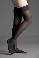 Beautiful woman legs on dark background photo